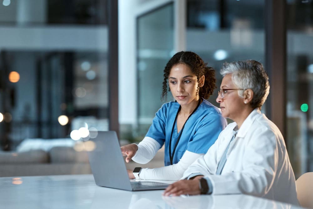 Healthcare workers collaborating with technology